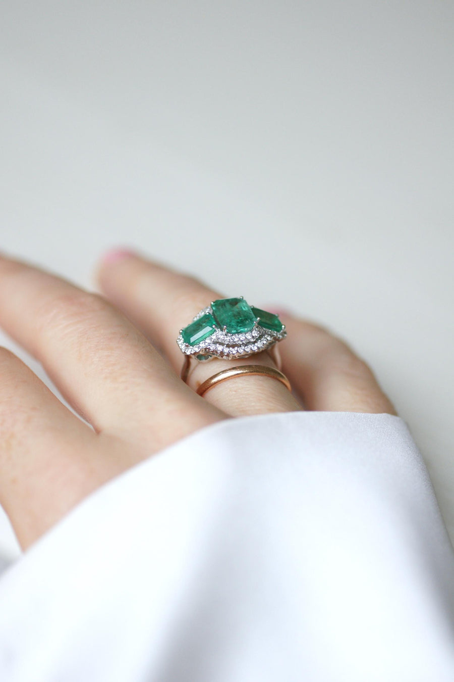 Ring Three Emeralds Surrounded by Diamonds on White Gold