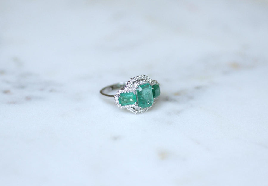 Ring Three Emeralds Surrounded by Diamonds on White Gold