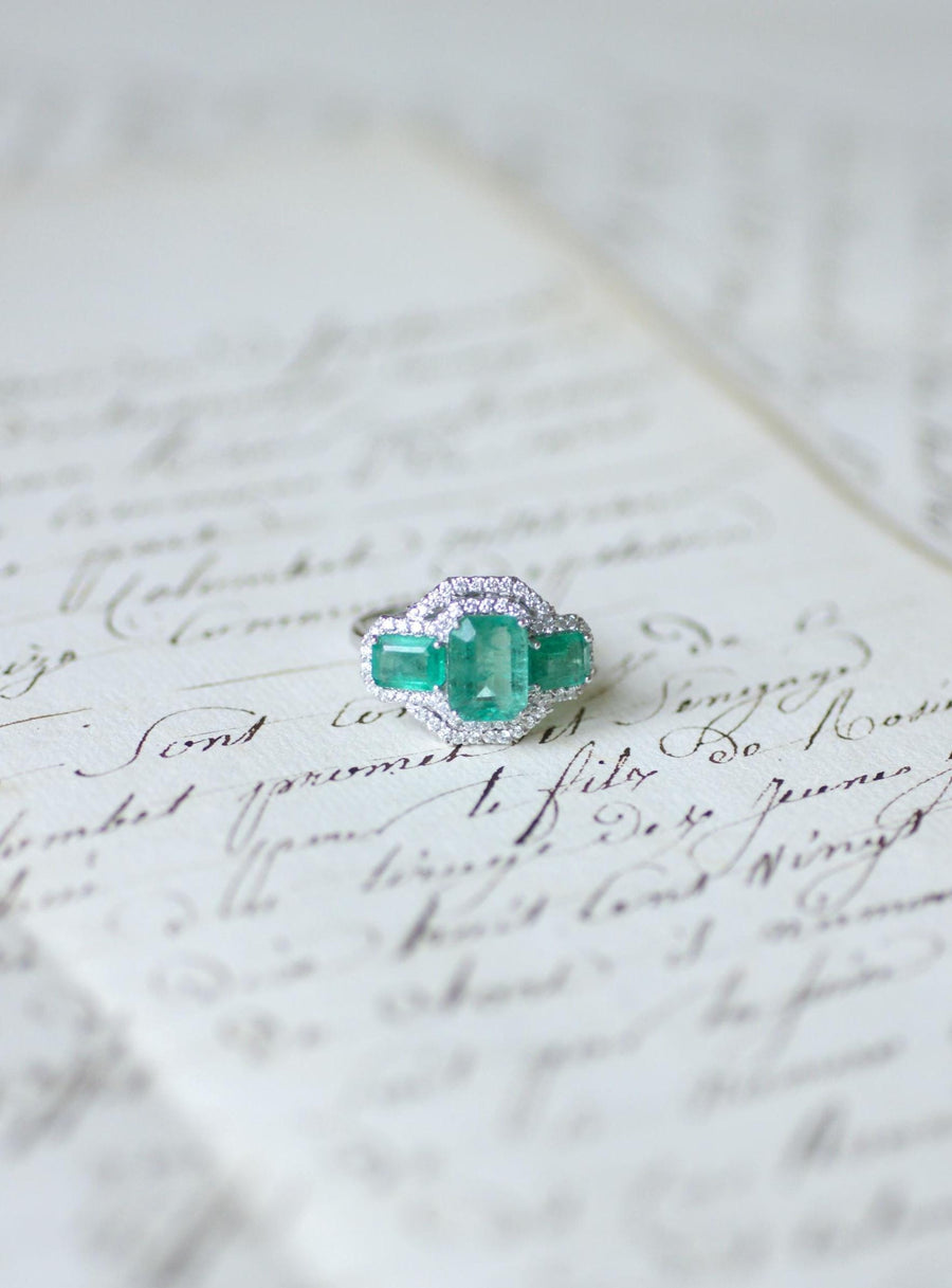 Ring Three Emeralds Surrounded by Diamonds on White Gold