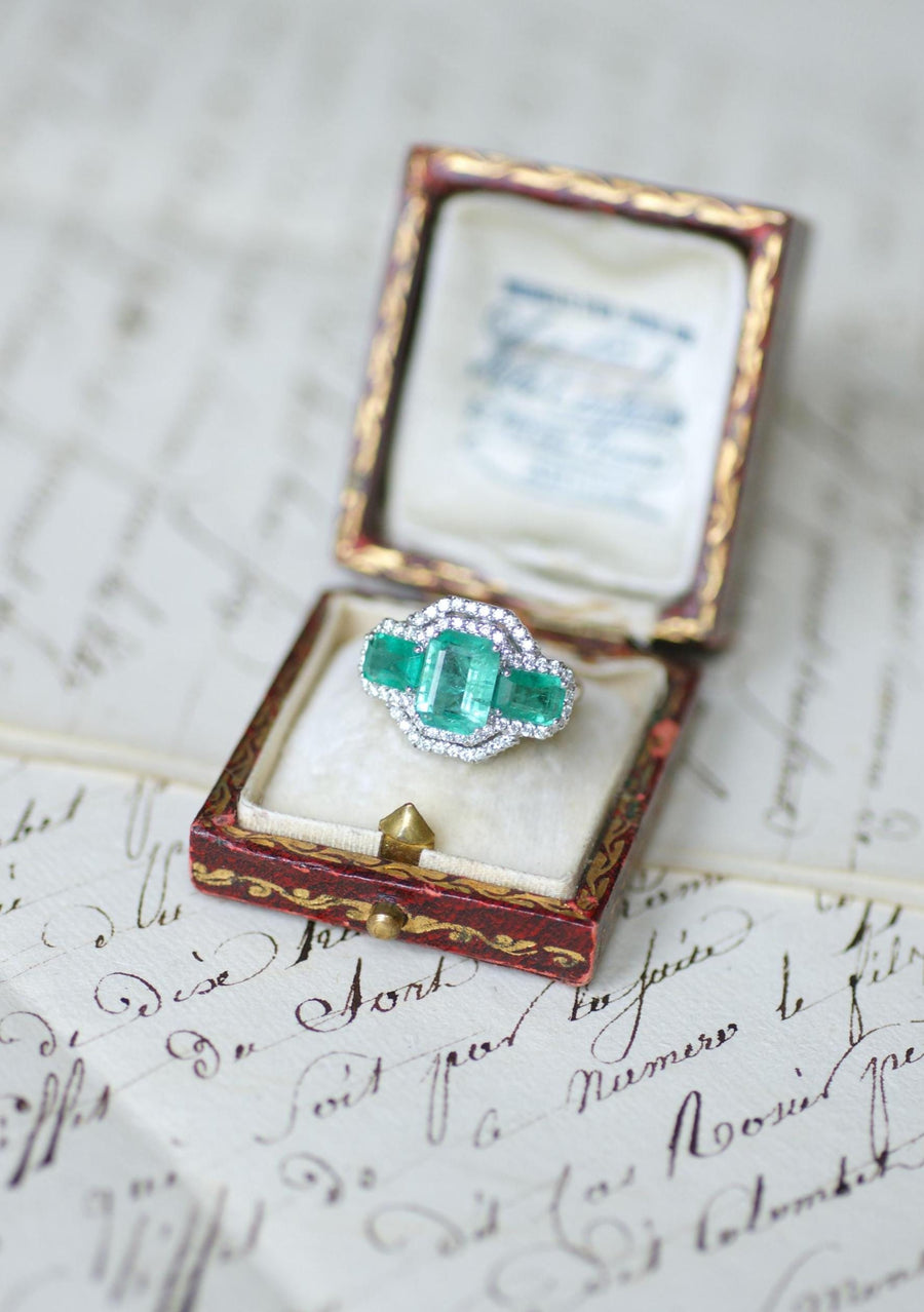 Ring Three Emeralds Surrounded by Diamonds on White Gold