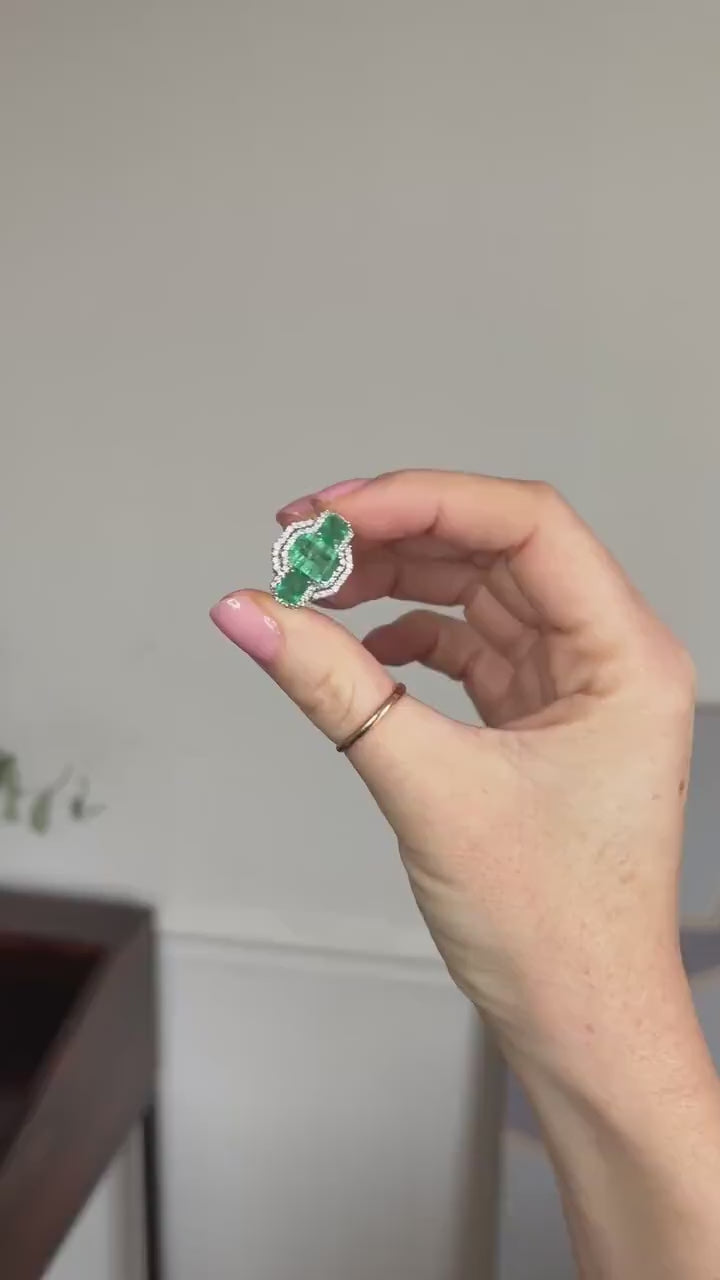 Ring Three Emeralds Surrounded by Diamonds on White Gold