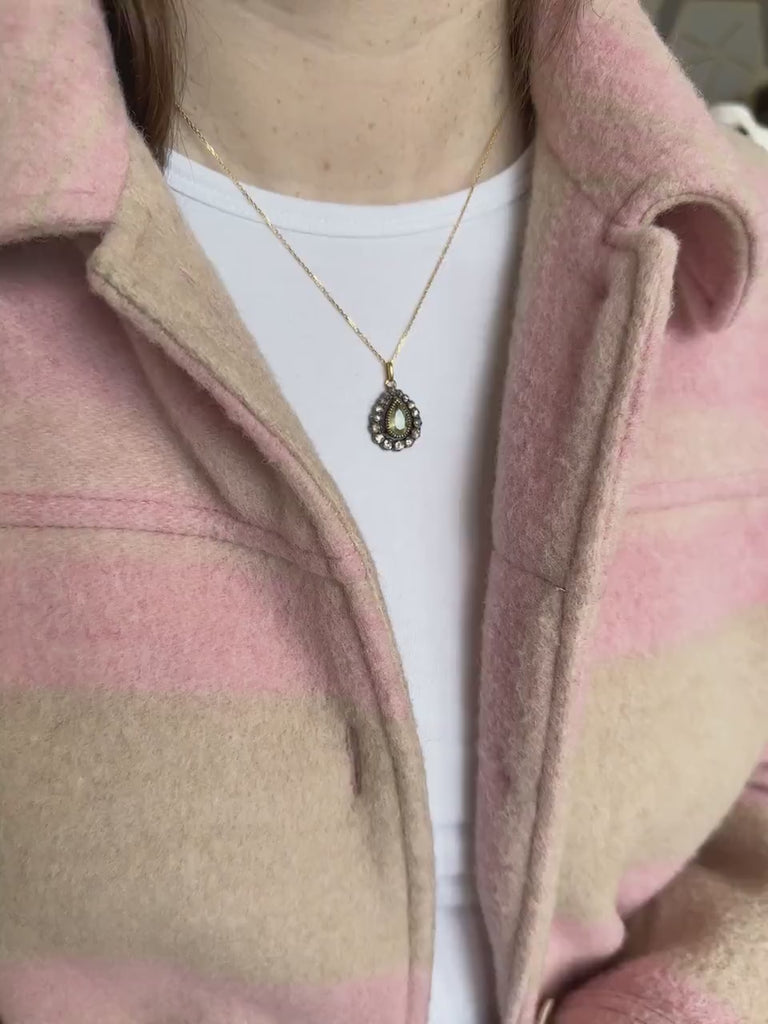 Gold necklace with antique green beryl drop pendant surrounded by diamonds