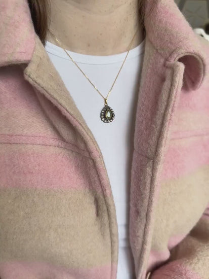 Gold necklace with antique green beryl drop pendant surrounded by diamonds