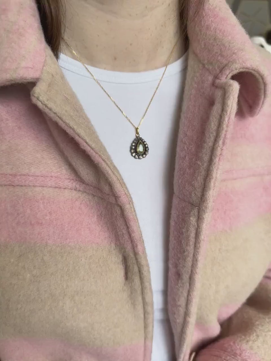 Gold necklace with antique green beryl drop pendant surrounded by diamonds