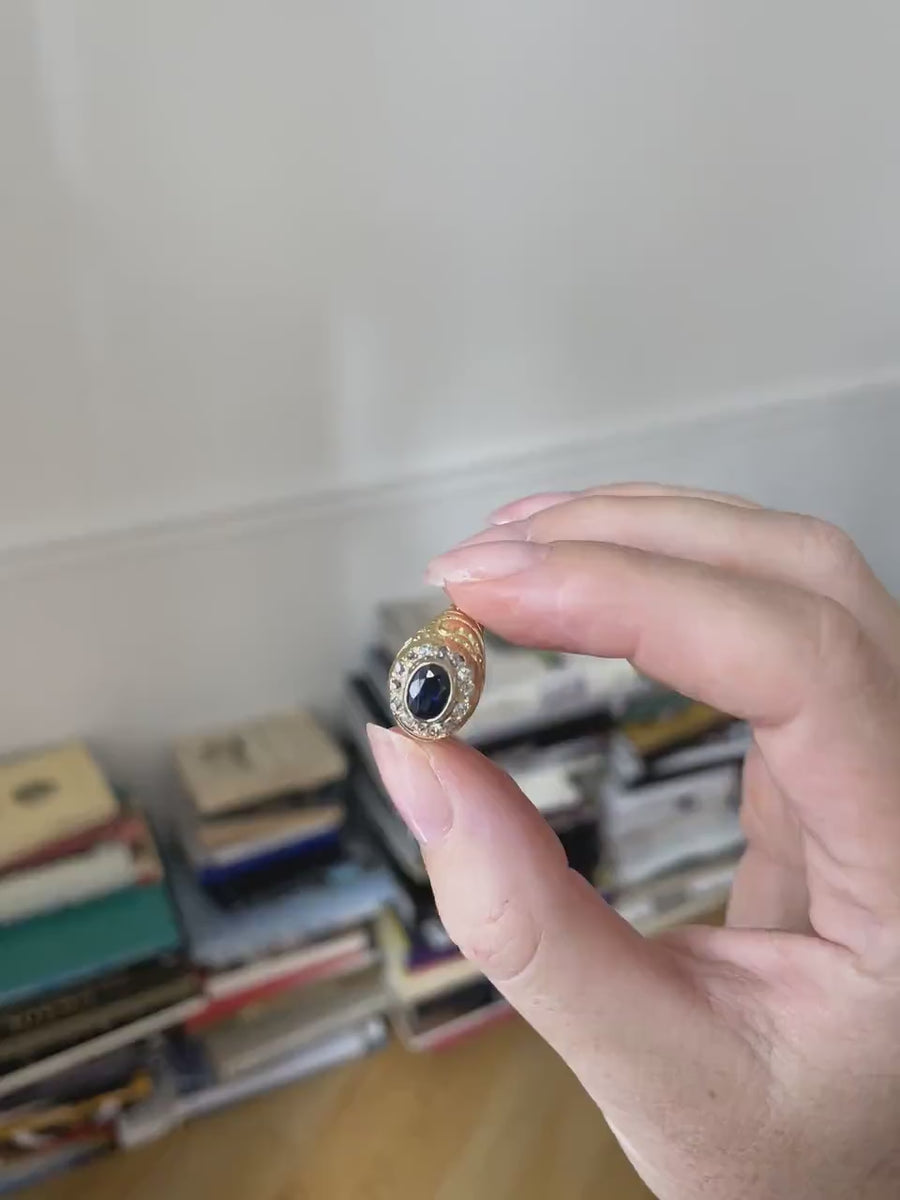 Antique dome ring, sapphire surrounded by diamonds on yellow gold
