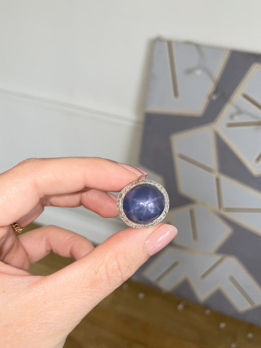 Star sapphire cabochon ring, diamond surround