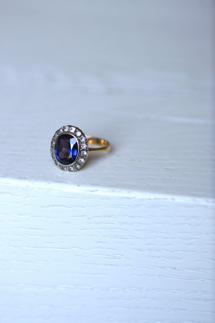 Synthetic sapphire daisy ring surrounded by white sapphires - Penelope Gallery