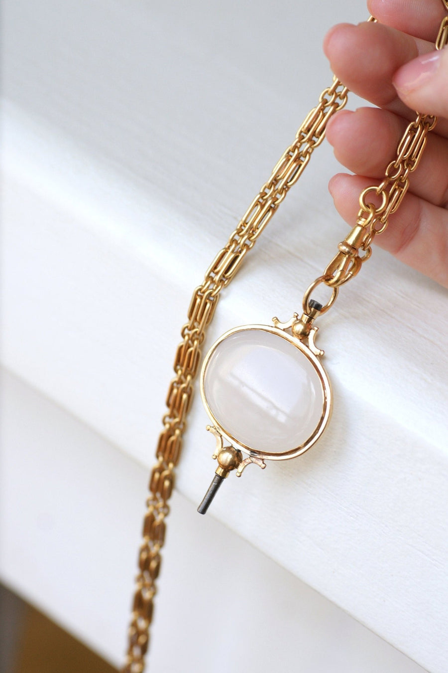 Chalcedony on gold watch key pendant - Galerie Pénélope